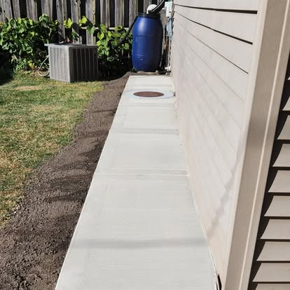 Fresh concrete sidewalk along residential property